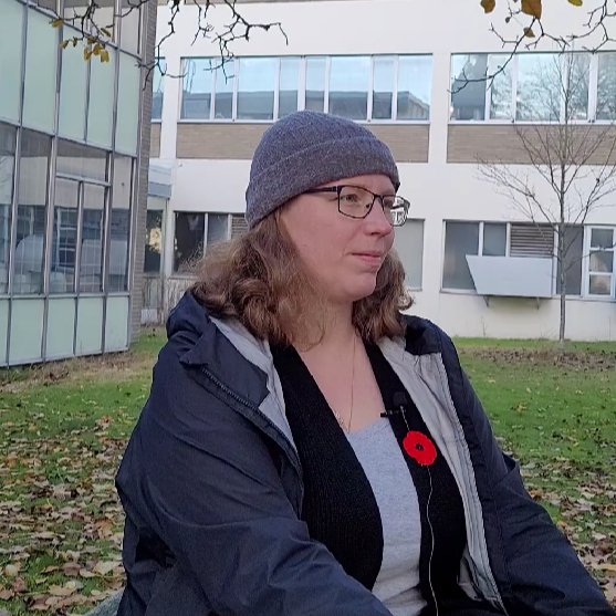 A person sitting down facing towards the right.