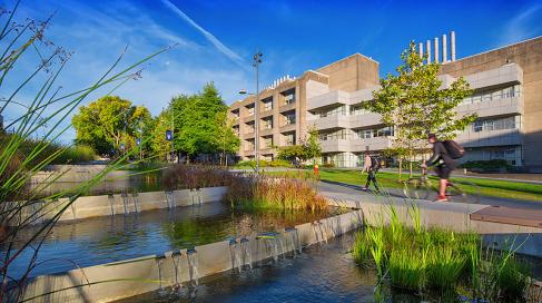 UBC Vancouver campus water feature with greenery and buildings in background