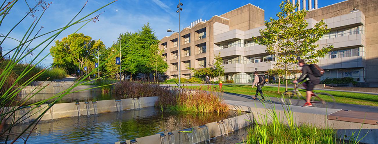 UBC Vancouver campus water feature with greenery and buildings in background