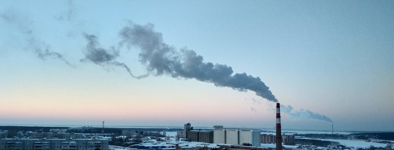 City skyline with steam emitting from building